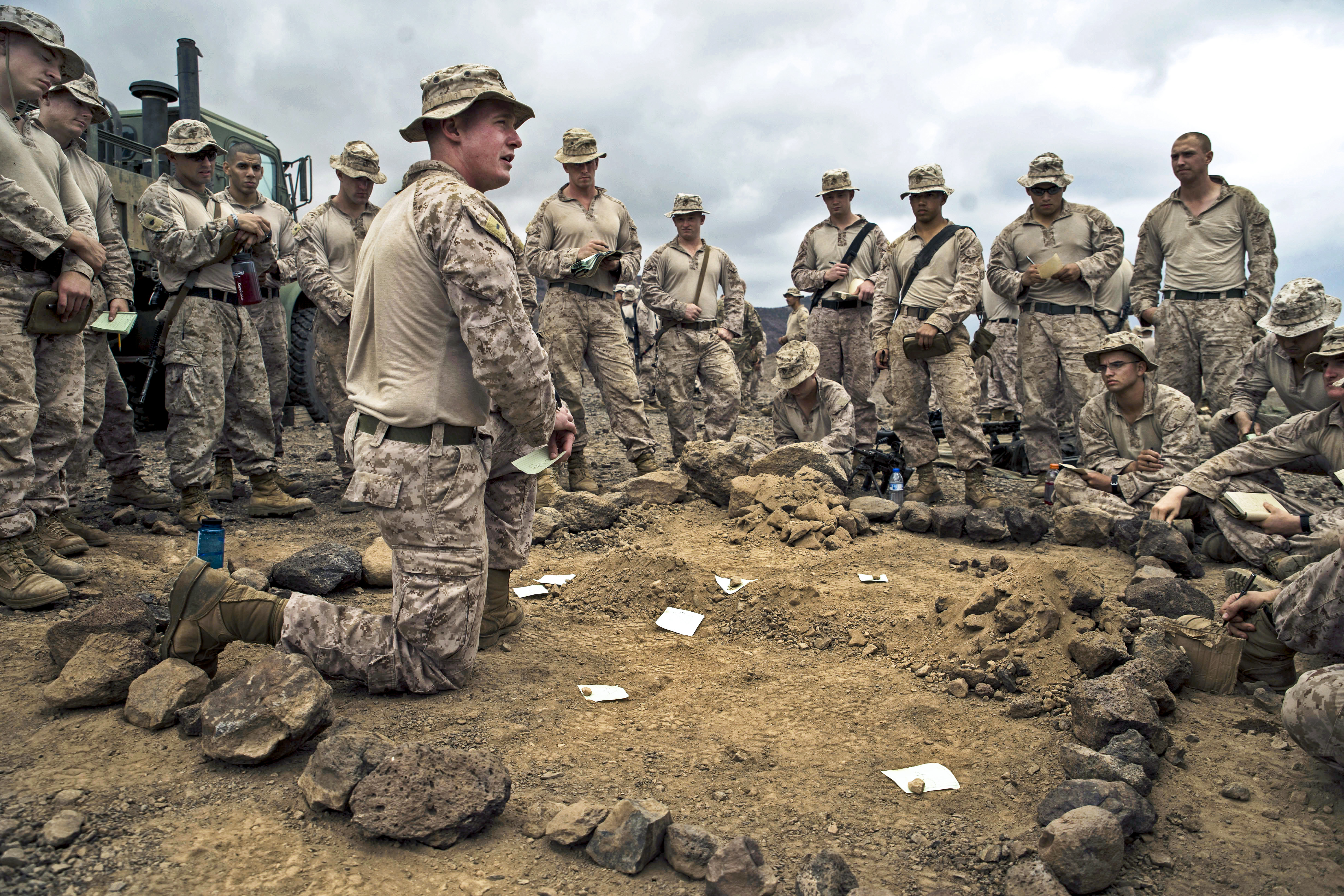 U.S. Marines with the 13th Marine Expeditionary Unit (MEU), Alpha Company 1/4, receive a briefing before a platoon assault exercise at Arta Range, Djibouti, Feb. 10, 2014. The 13th MEU is deployed with the Boxer Amphibious Ready Group as a theater reserve and crisis response force throughout the U.S. 5th Fleet area of responsibility.(U.S. Air Force photo by Staff Sgt. Erik Cardenas/Released)